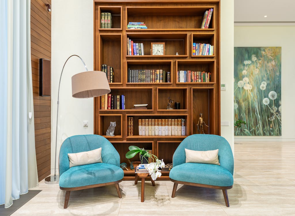 How Sioux Falls Flooring Trends Should Influence What You Install in Your Home (2026) Living room with cozy chairs near lamp and wooden bookcase