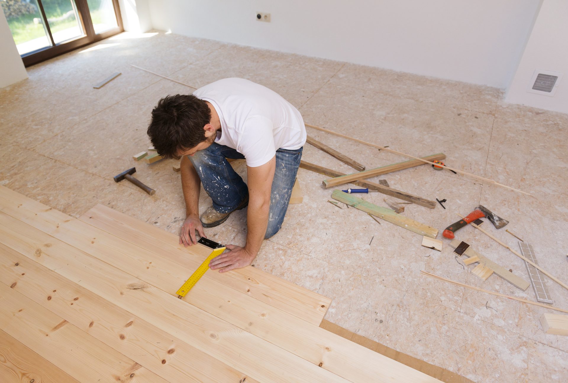 Graphicstock Man Measuring Wood Flooring In New House HAFk T3bW Scaled